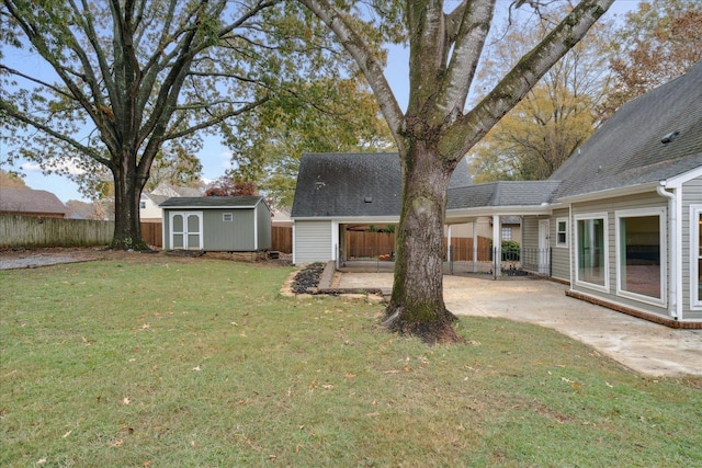 view of yard with a patio area and a storage unit