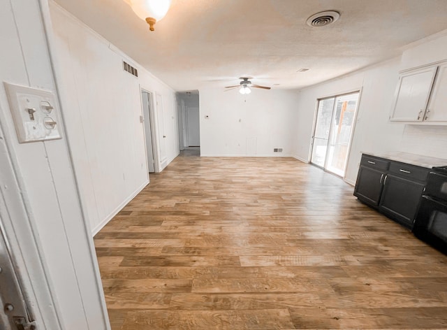 unfurnished living room featuring light hardwood / wood-style floors and ceiling fan