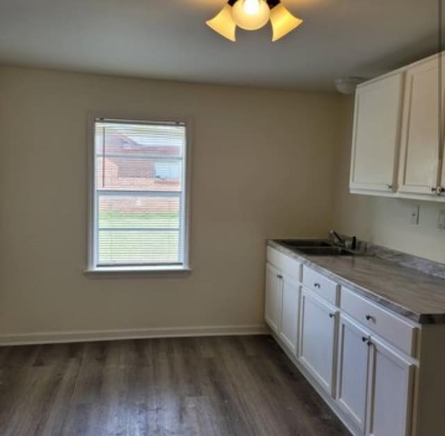 kitchen featuring white cabinets, ceiling fan, dark wood-type flooring, and sink