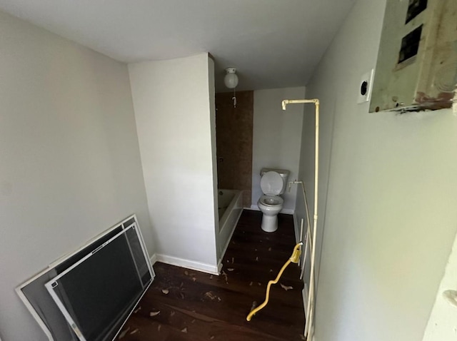 bathroom featuring bathing tub / shower combination, wood-type flooring, and toilet