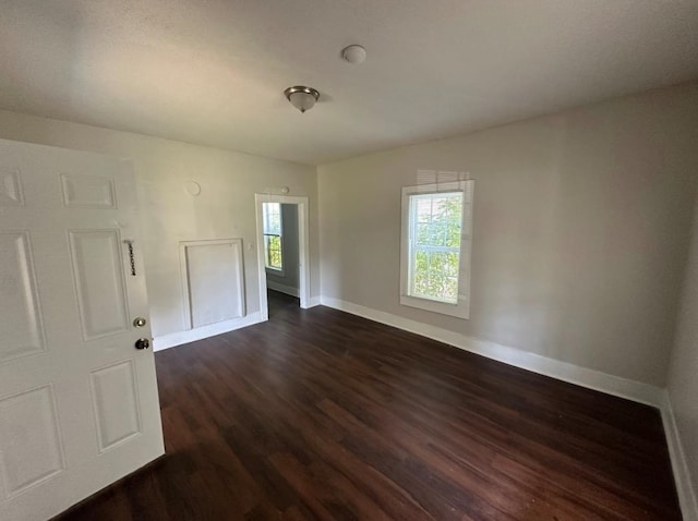 unfurnished room featuring dark wood-type flooring