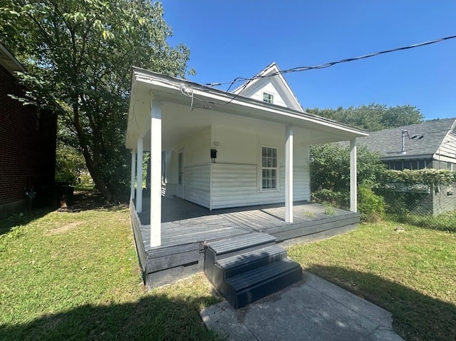 view of home's exterior with a lawn and covered porch