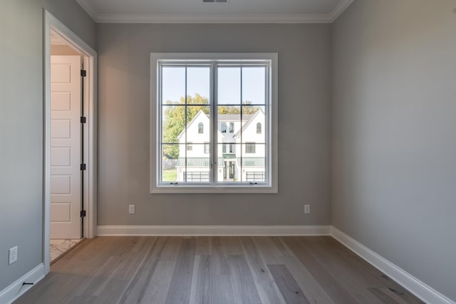 unfurnished room with wood-type flooring and crown molding