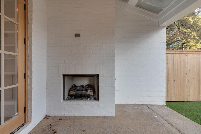 exterior space with an outdoor brick fireplace