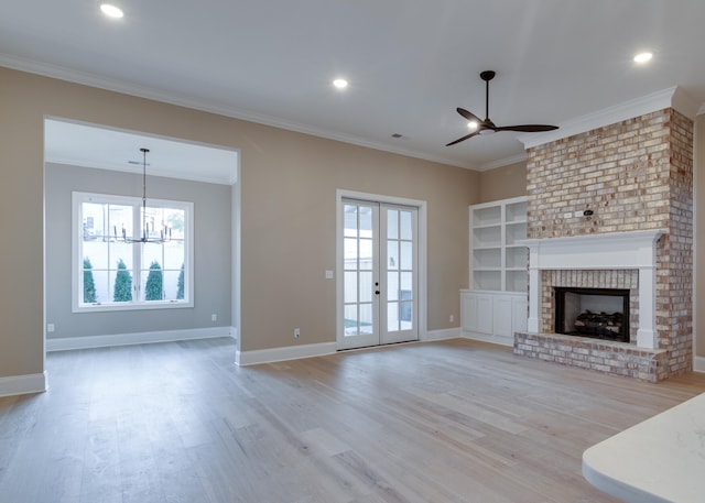 unfurnished living room with a fireplace, ornamental molding, a healthy amount of sunlight, and light wood-type flooring