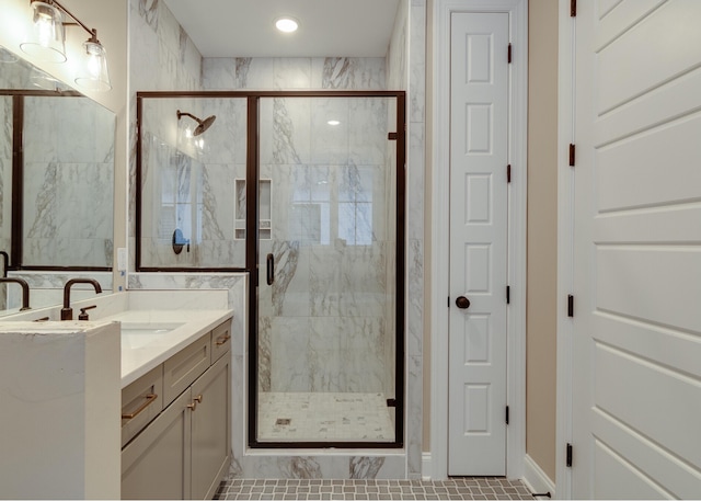 bathroom featuring tile patterned flooring, vanity, and walk in shower