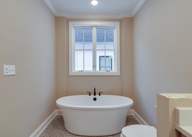 bathroom with a bathing tub, toilet, ornamental molding, and tile patterned floors