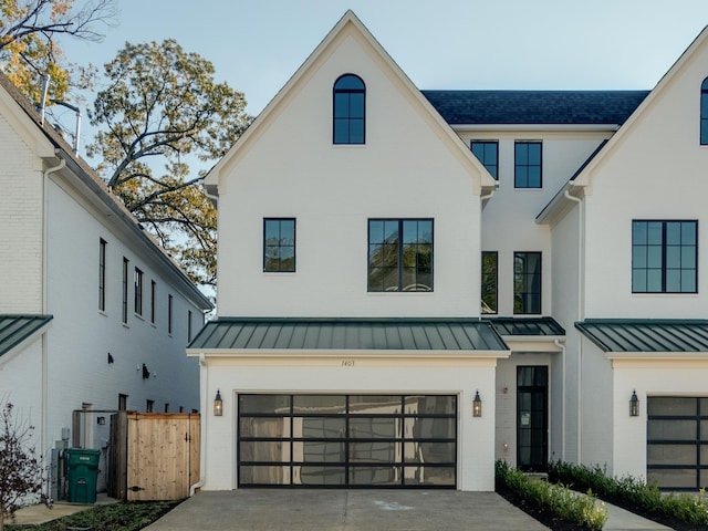 modern inspired farmhouse with a garage