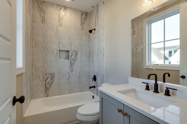 full bathroom with vanity, toilet, and tiled shower / bath