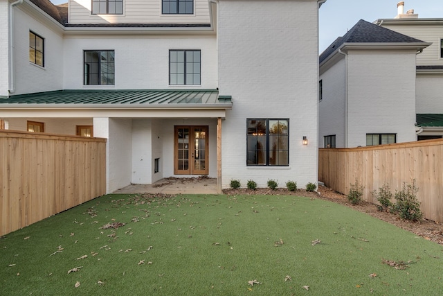 rear view of property with a yard