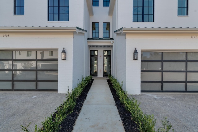 entrance to property featuring a garage and french doors