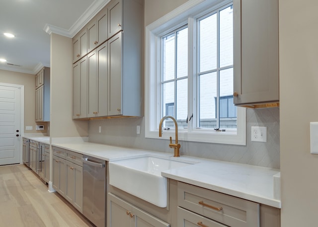 kitchen featuring dishwasher, gray cabinets, ornamental molding, and sink