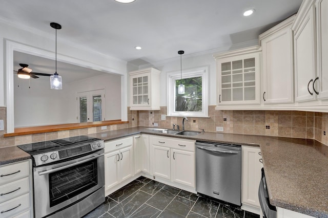 kitchen featuring white cabinets, hanging light fixtures, and appliances with stainless steel finishes