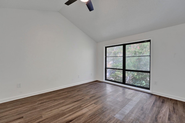 spare room with dark wood-type flooring, ceiling fan, and lofted ceiling