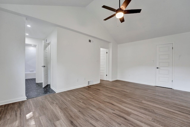 empty room featuring dark hardwood / wood-style floors, high vaulted ceiling, and ceiling fan