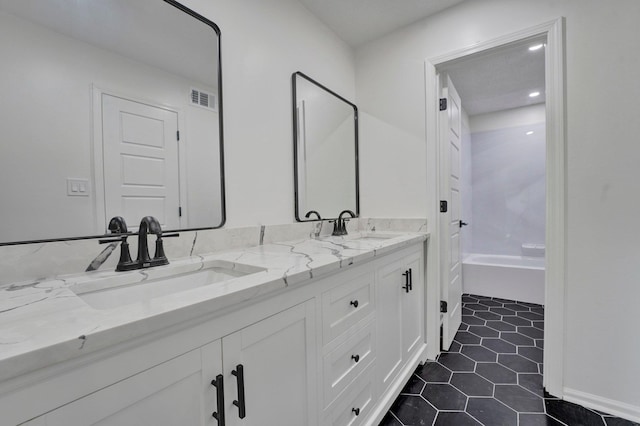 bathroom with tile patterned flooring and vanity