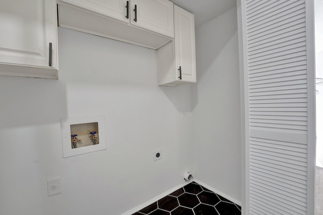 laundry area with hookup for an electric dryer, washer hookup, and cabinets