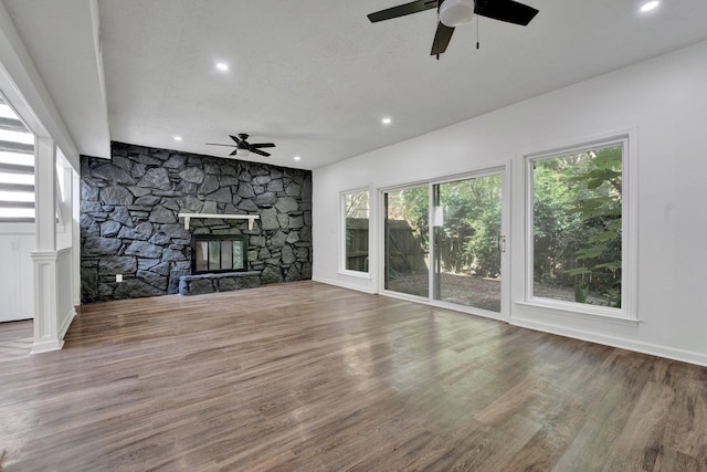 unfurnished living room with a fireplace, hardwood / wood-style floors, a textured ceiling, and ceiling fan