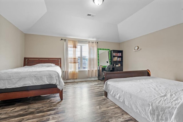 bedroom with dark wood-type flooring and vaulted ceiling