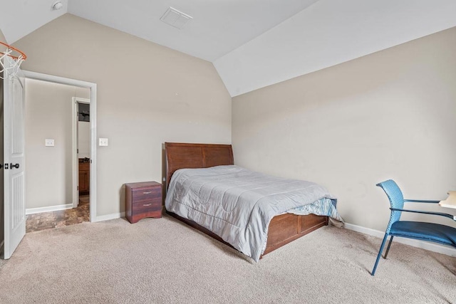 carpeted bedroom with vaulted ceiling