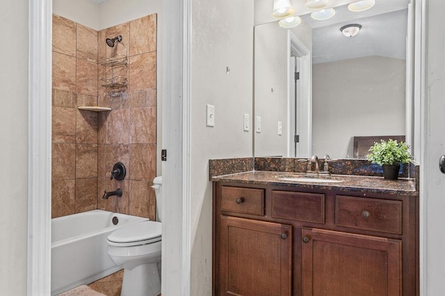 full bathroom featuring vanity, tile patterned floors, tiled shower / bath combo, and toilet