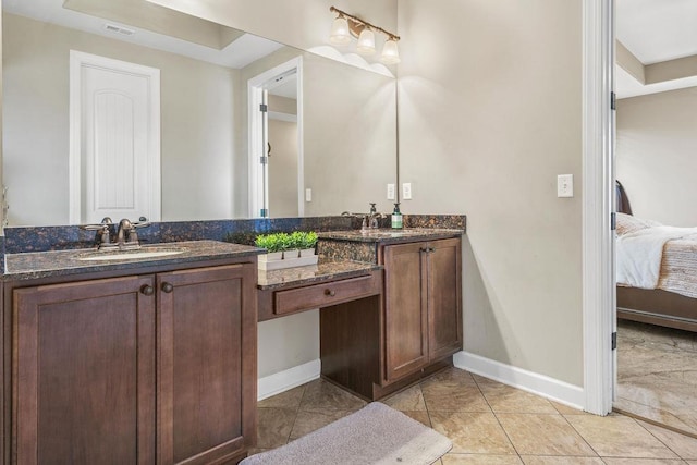 bathroom with tile patterned flooring and vanity