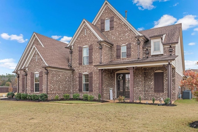 view of front of property featuring central AC and a front lawn