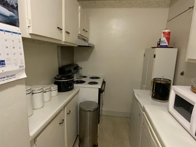 kitchen with white appliances, white cabinetry, and extractor fan