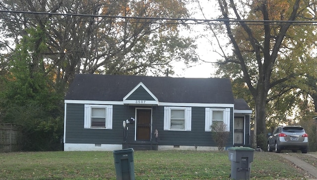 bungalow-style home with a front yard