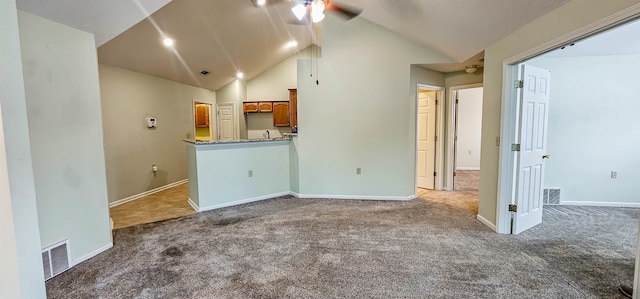 unfurnished living room featuring dark colored carpet, ceiling fan, and lofted ceiling