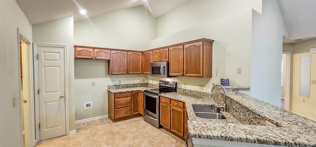 kitchen with light stone countertops, stainless steel appliances, sink, light tile patterned floors, and high vaulted ceiling