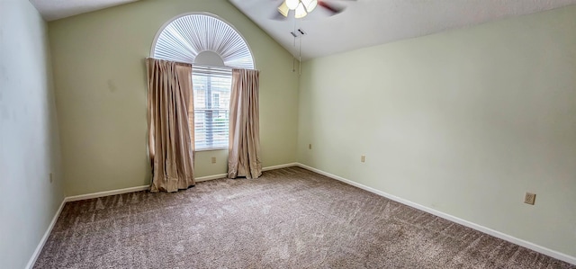 empty room with carpet flooring, a wealth of natural light, ceiling fan, and vaulted ceiling