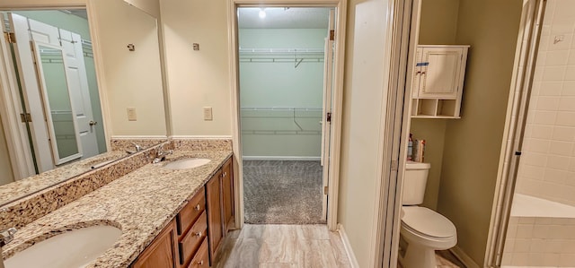 bathroom featuring vanity, toilet, and walk in shower