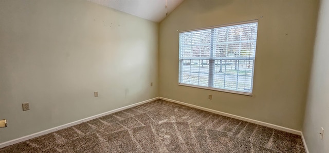 empty room featuring carpet flooring and lofted ceiling