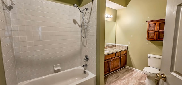 full bathroom with hardwood / wood-style floors, vanity, toilet, and tiled shower / bath