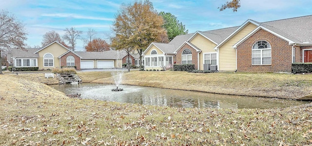 view of front of property featuring central AC unit and a front lawn