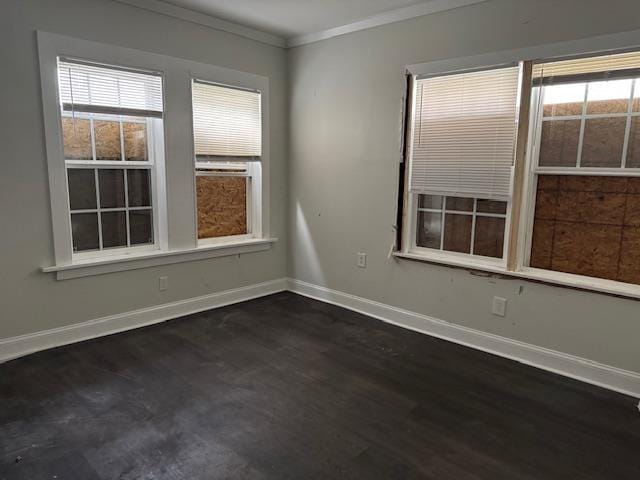 unfurnished room with dark wood-type flooring and crown molding