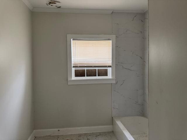 bathroom with a bathtub and ornamental molding