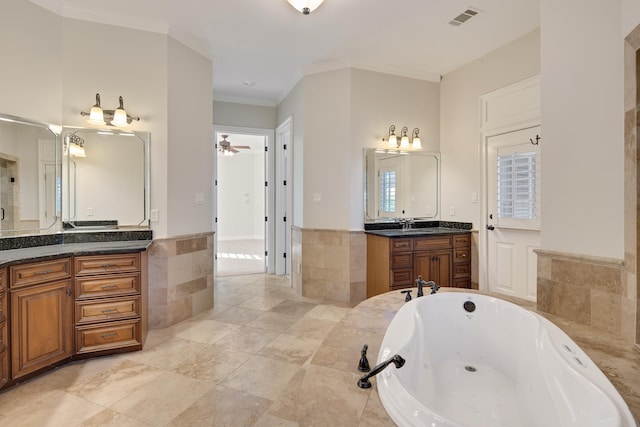 bathroom featuring tile patterned floors, ornamental molding, vanity, ceiling fan, and tile walls