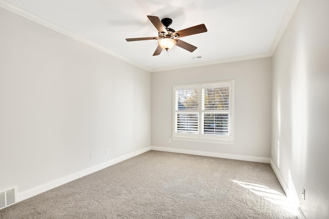 carpeted spare room featuring ceiling fan and ornamental molding