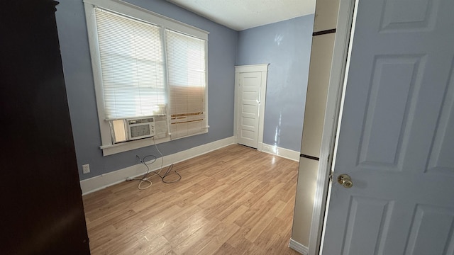 unfurnished room featuring light hardwood / wood-style flooring and cooling unit