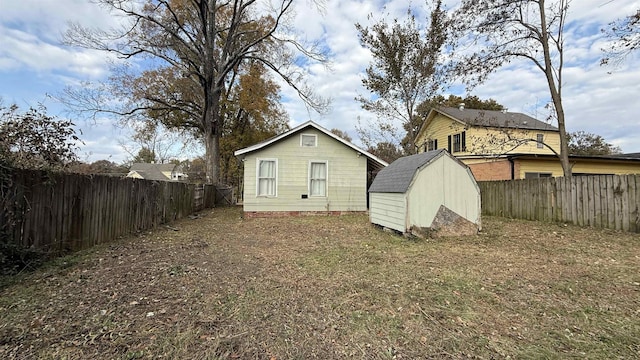 back of house featuring a storage unit