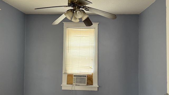 details with ceiling fan, cooling unit, and a textured ceiling