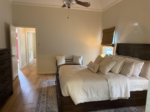 bedroom with ceiling fan, crown molding, and hardwood / wood-style flooring