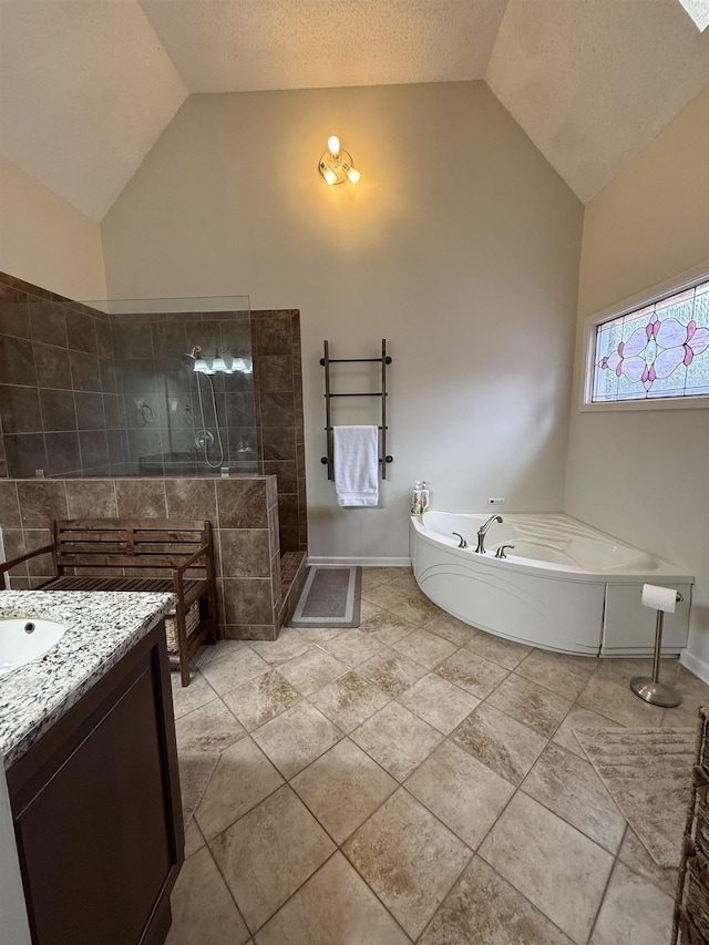 bathroom featuring a textured ceiling, vanity, independent shower and bath, and vaulted ceiling