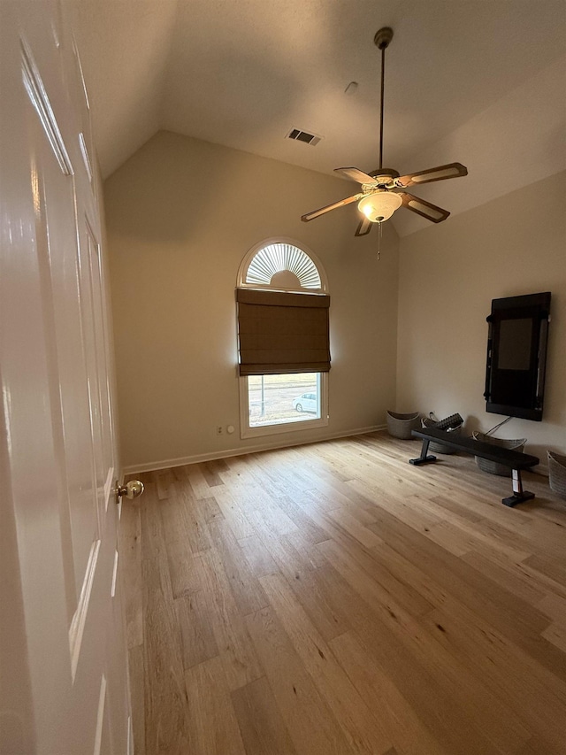 unfurnished living room with light hardwood / wood-style flooring, ceiling fan, and lofted ceiling