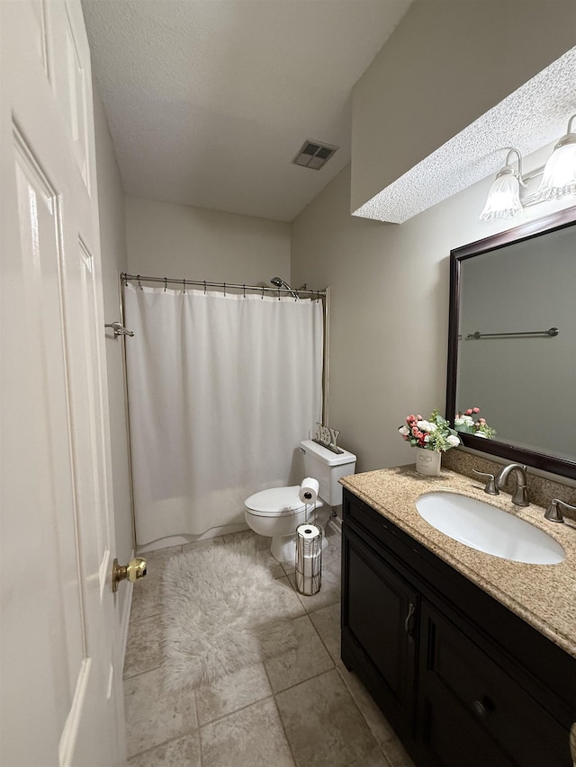 bathroom with curtained shower, vanity, a textured ceiling, and toilet