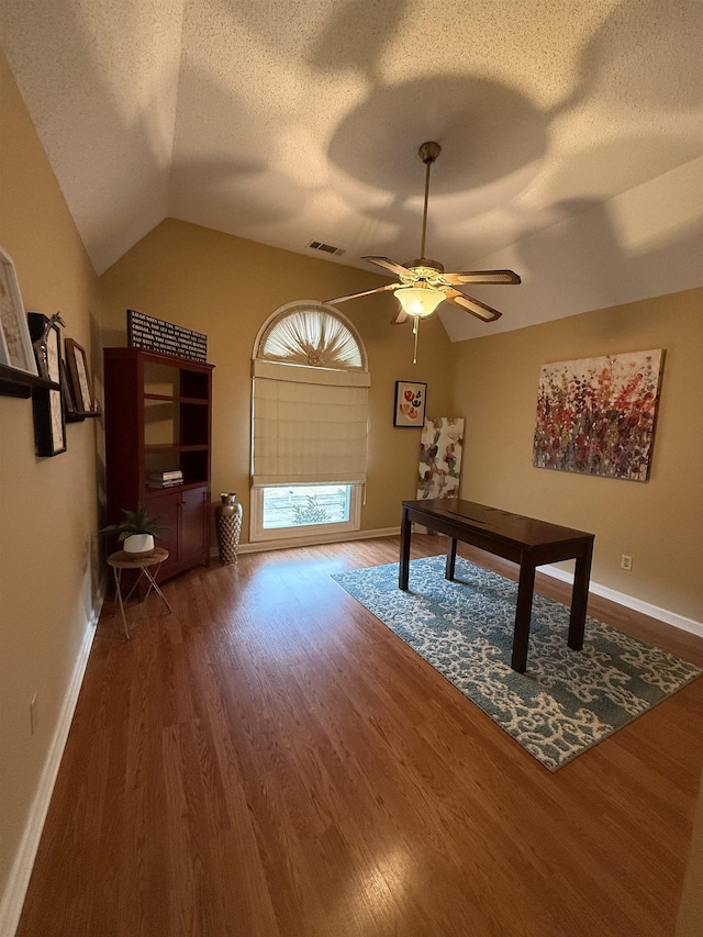 office area featuring a textured ceiling, hardwood / wood-style flooring, ceiling fan, and lofted ceiling