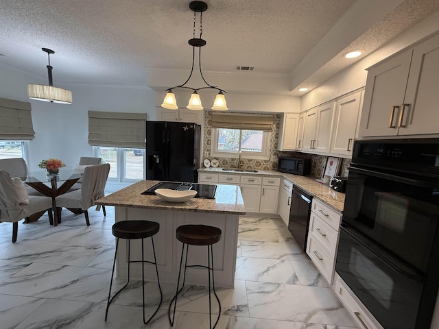 kitchen featuring tasteful backsplash, plenty of natural light, and black appliances