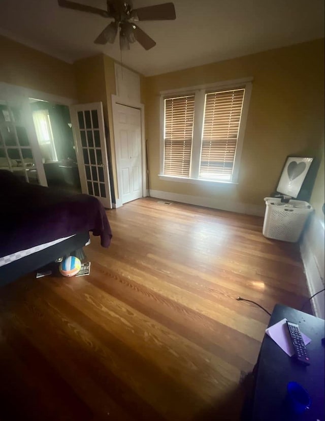 bedroom with ceiling fan and wood-type flooring